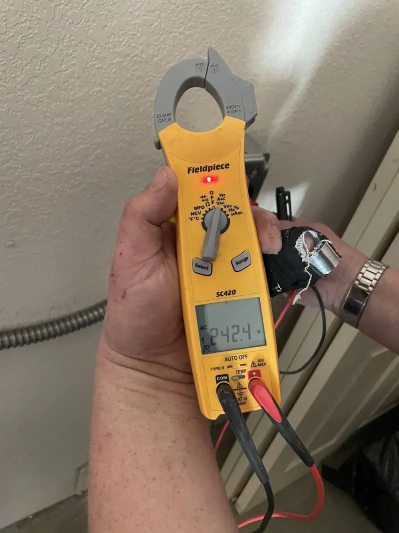 Voltage testing with clamp meter during Whole House Surge Protector in Southern Shores